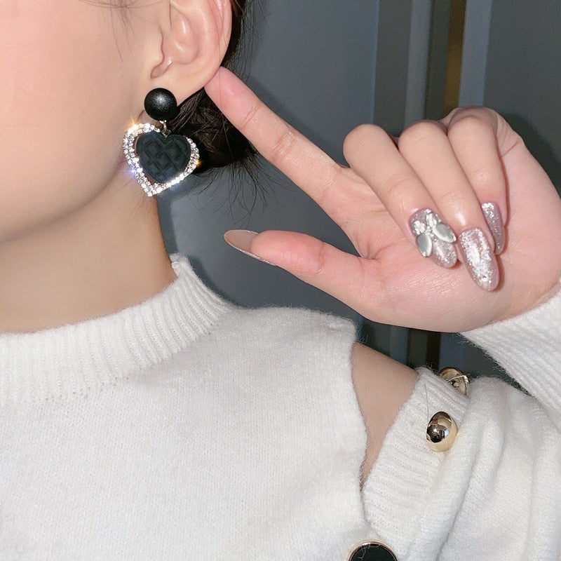 Boucles d'oreilles noires et dorées en forme de cœur